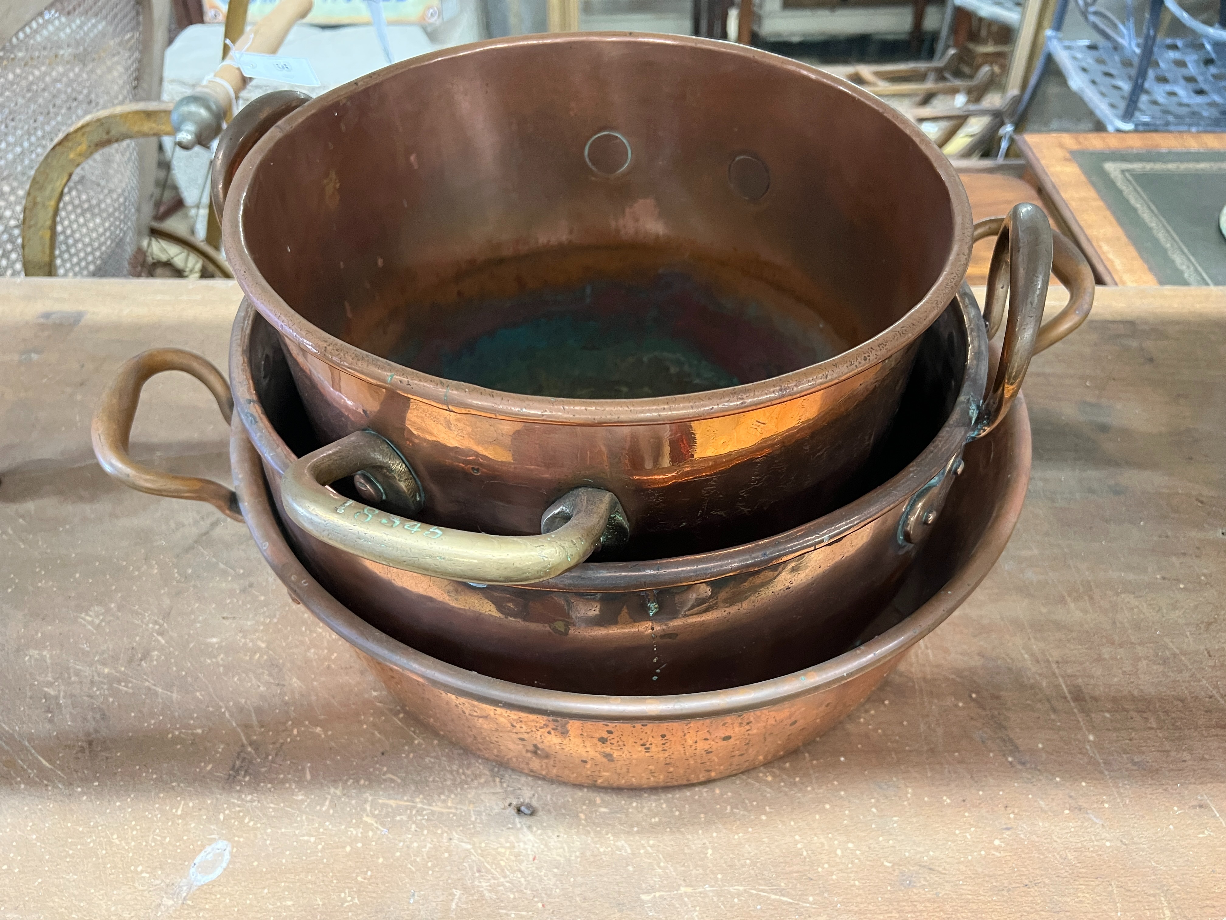 Three Victorian circular copper two handled preserve pans, largest diameter 43cm